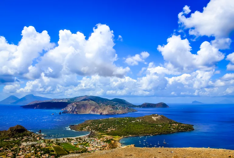 Aeolian Islands panorama with sailboats at anchor, seen from Vulcano