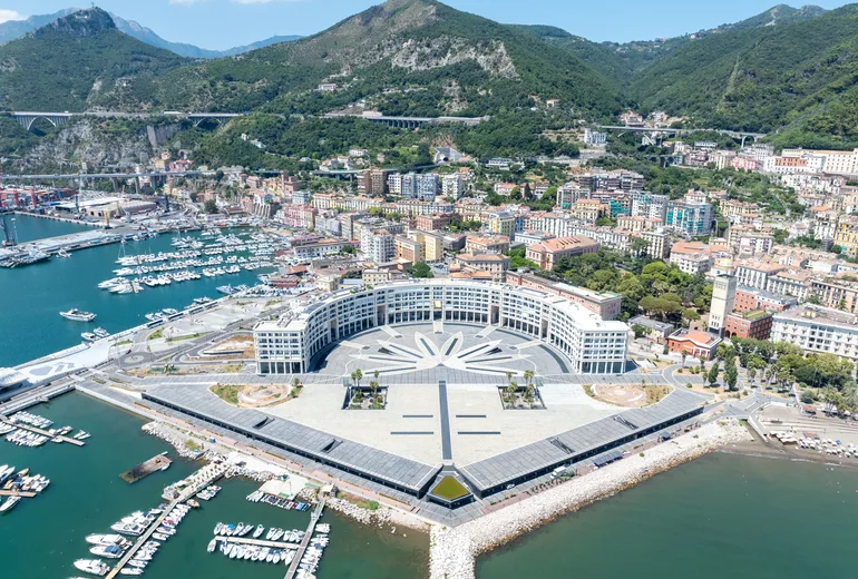 Aerial view of Salerno waterfront with a crescent-shaped modern plaza and yacht marinas