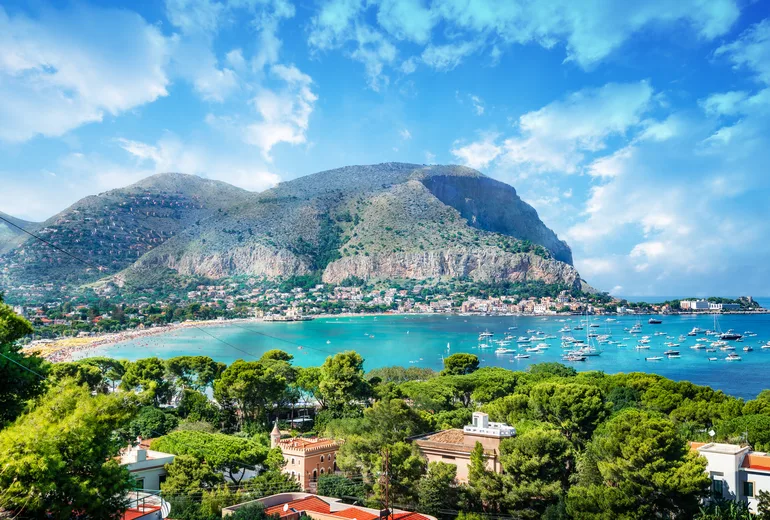 Mondello bay near Palermo dotted with moored boats, Monte Pellegrino backdrop, Sicily