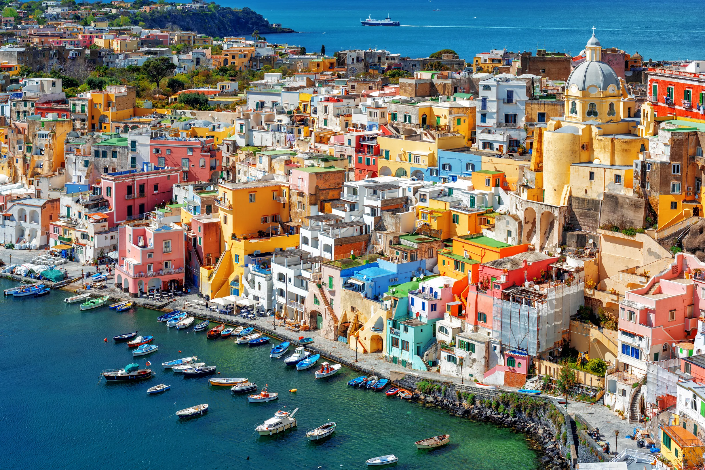 Pastel fishing village houses above Marina Corricella harbor, Procida island
