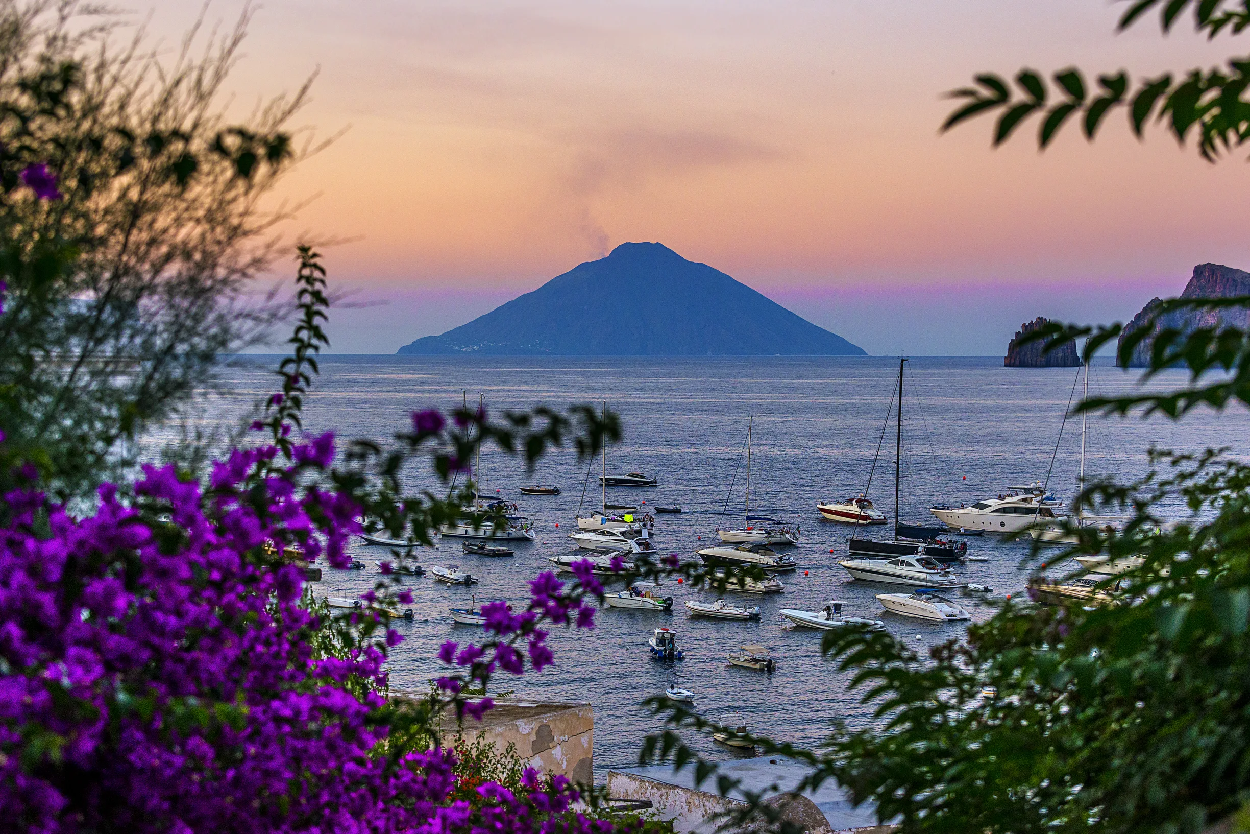 Stromboli volcano at dusk with boats at anchor in the Aeolian Islands