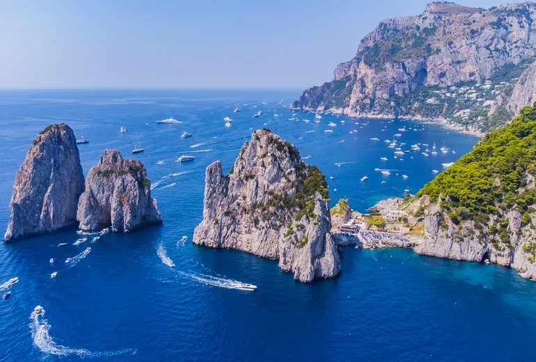 Yachts around the Faraglioni sea stacks off Capri
